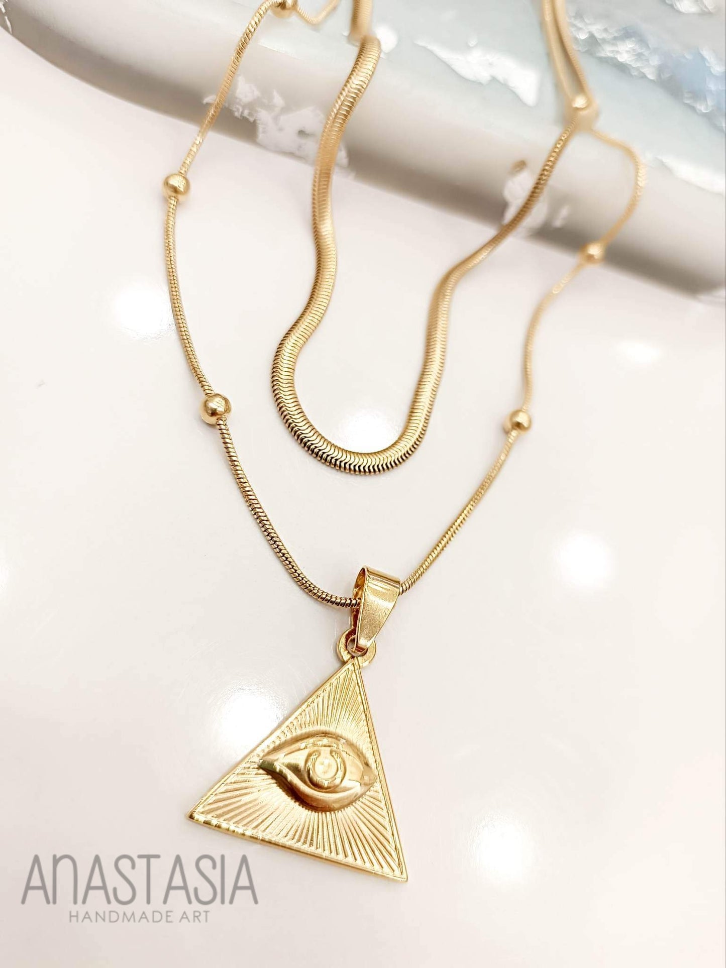 Necklace with evil eye in triangle
