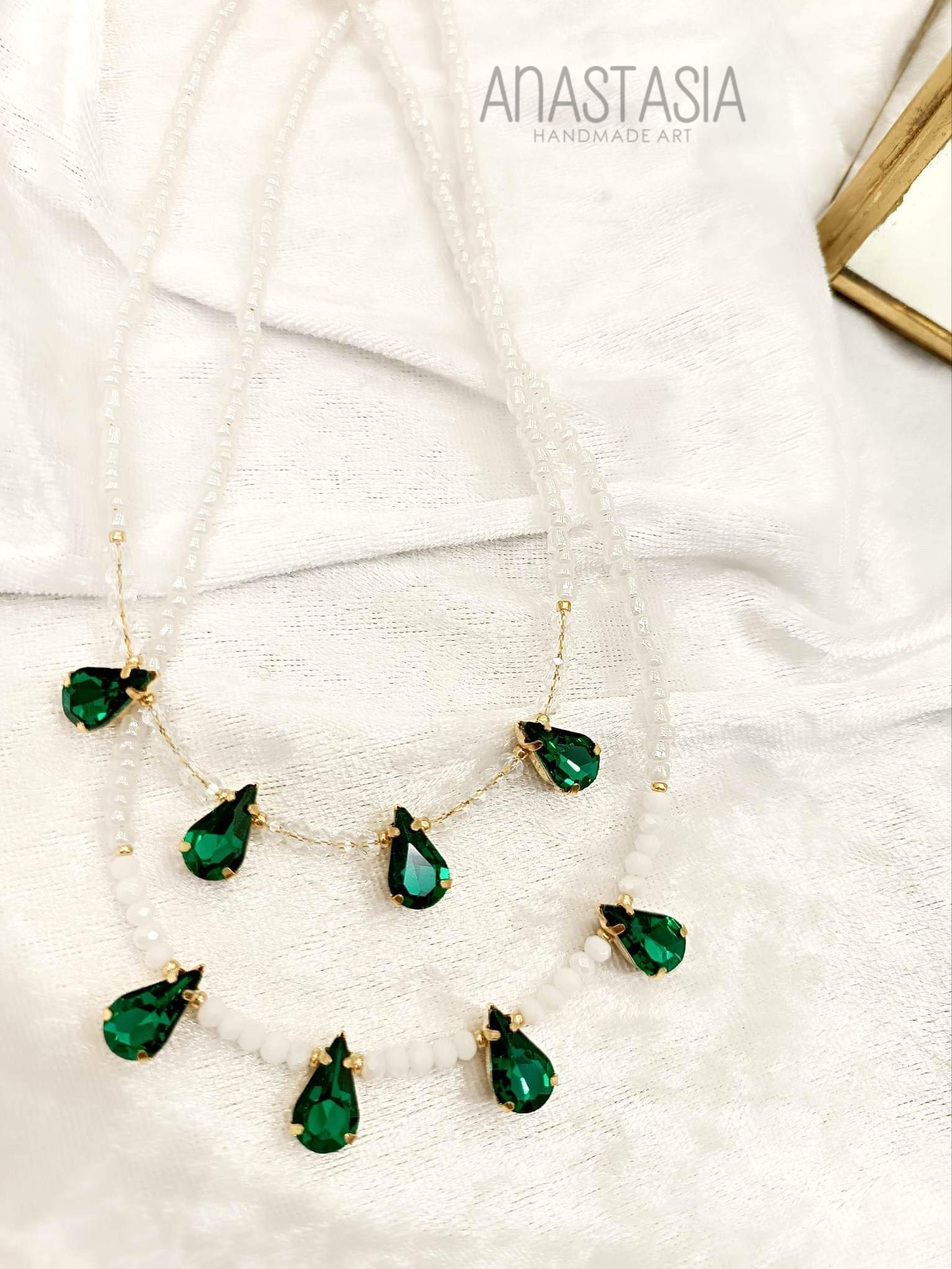 Necklace with white beads and green stone charm
