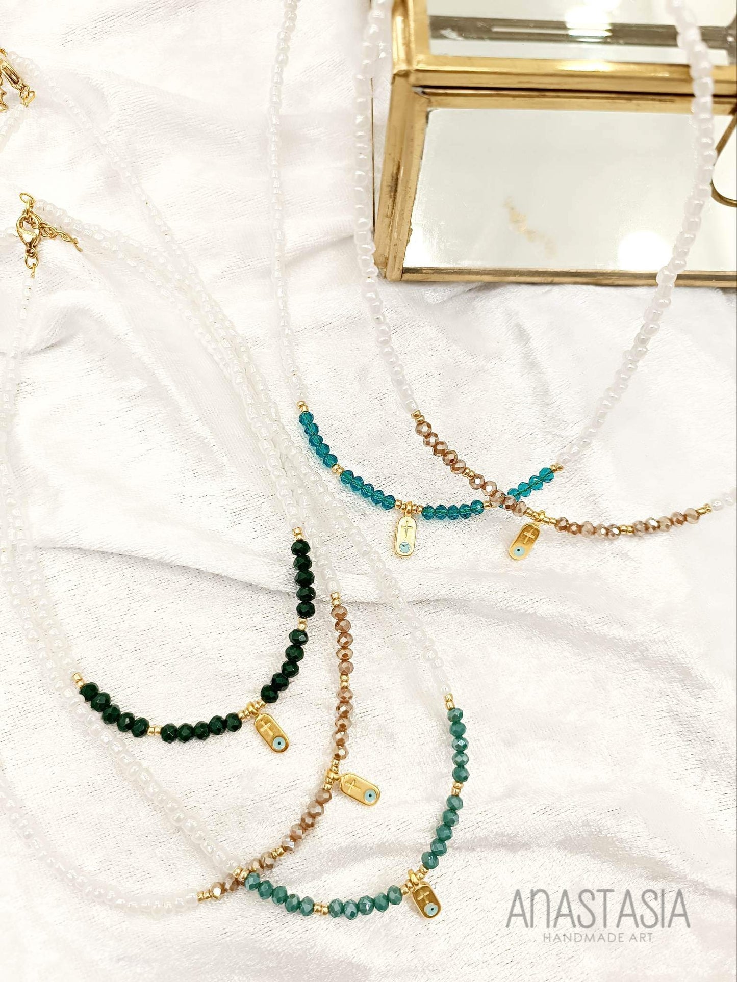Necklace with beads and evil eye-cross