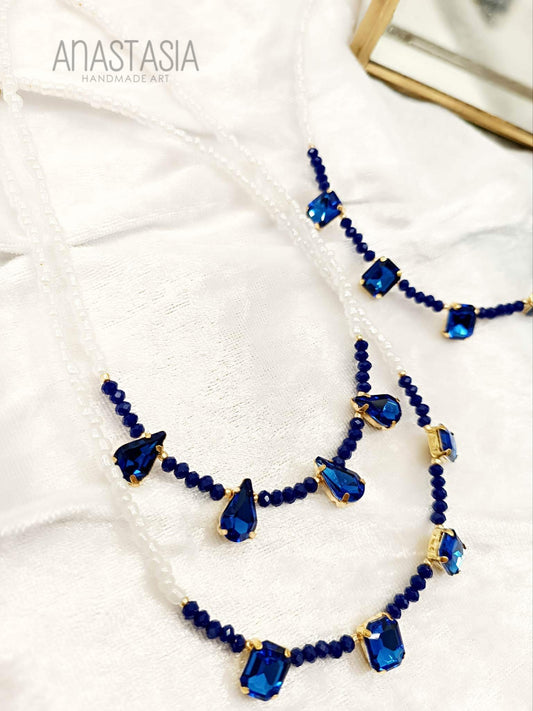 Necklace with white beads and blue stone charm